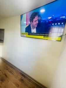 a flat screen tv hanging on a wall at Felton Motel in Breezewood