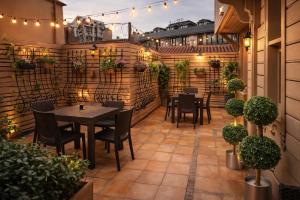 a patio with tables and chairs and lights at valide-maide hotel in Istanbul