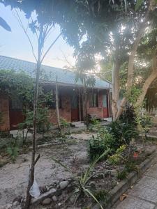 a house with a garden in front of it at Homestay Mỹ Ánh 1 in Phú Quốc