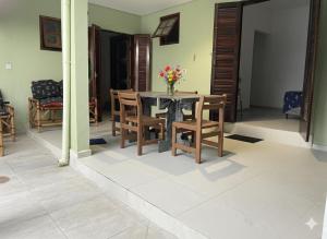 a dining room with a table and chairs at Pousada NASCER DO SOL in Bertioga