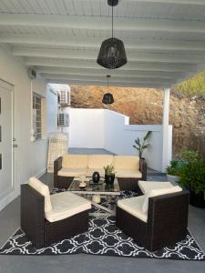 a patio with a couch and chairs and a table at Modern Ocean View Apartment in Upper Prince's Quarter