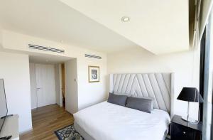 a bedroom with a large white bed with two pillows at Departamento Andares in Guadalajara