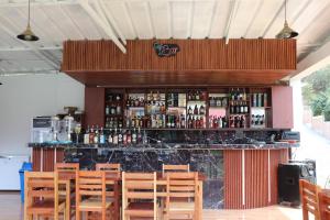 a bar with a bunch of bottles of alcohol at Alpinas Natural Suites in Lunahuaná