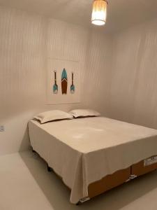 a bed in a white room with at Casa Carnaubas in Icapuí