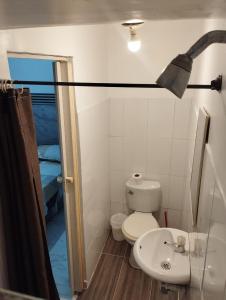 a bathroom with a toilet and a sink and a shower at El Hogar de Ami in Cali +43 photos