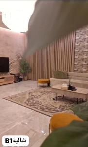 a living room with a couch and a table at chalet B1 in Al Khīrān