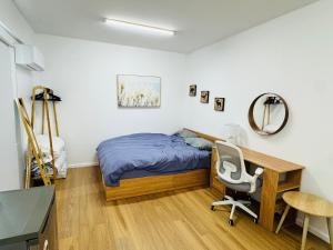 a bedroom with a bed and a desk and a chair at Quiet and Cozy corner in Braybrook