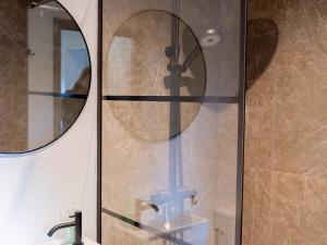 a shower with a mirror and a sink at Uilenhof in Epe +27 photos