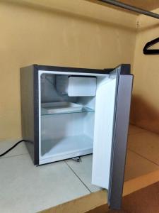 an empty refrigerator with its door open in a room at Hotel Aldea Cruzo'ob in Felipe Carrillo Puerto +10 photos