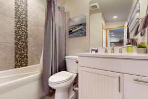 a bathroom with a toilet and a sink and a tub at Whalehouse in Tyee Beach +18 photos