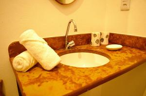 a bathroom counter with a sink and a towel at Casarão Duque do Mel in João Pessoa +44 photos