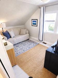 a living room with a couch and a window at Seaside Cottage 180 Views in Petit-Etang
