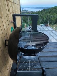 a black table and chair on a deck at Casa Esquila de Chiloé in Chonchi