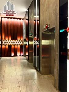 a hallway with a row of elevators in a building at The Shore Kota Kinabalu by Ems Executive Suites Seaview in Kota Kinabalu