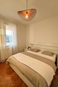 a bedroom with a large bed and a window at Apartments with parking space Korcula - 180 in Korčula