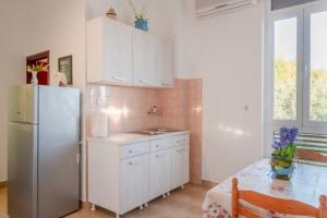 a kitchen with a stainless steel refrigerator and a table at Studio Prizba 12648d in Prizba