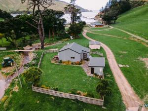 an aerial view of a small house on a hill at Arapawa Homestead in Picton
