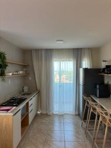 a kitchen with a stove and a counter top at Flat com vista mar in Mucuri