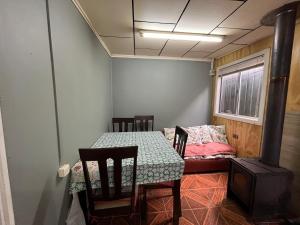 a room with a table and a bed and a stove at apartamento en centro de Castro in Castro