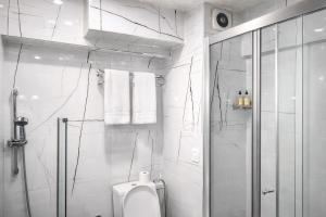 a white bathroom with a shower and a toilet at Valide i Suit in Istanbul +62 photos