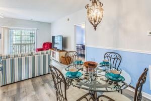 a dining room with a glass table and chairs at Condo w/ Pool Access, 1 Mi to Cherry Grove Beach in Myrtle Beach