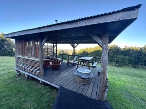 a wooden deck with a table and a grill at Terrazas altos de Gamboa in Castro