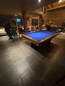 a pool table sitting on a tile floor in a room at La Casona del atardecer in San Antonio de las Alzanas