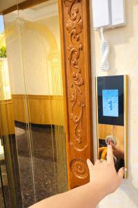 a person is unlocking a door with a ipod at Bình Dương Đà Lạt Hotel in Da Lat