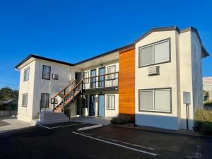 an apartment building with a staircase in front of it at Sunbeam Motel in San Luis Obispo
