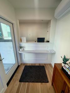 a small room with a desk and a window at Sunbeam Motel in San Luis Obispo