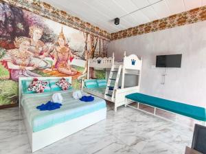 a bedroom with two beds and a mural at บ้านสวนชมจันทร์ กำแพงแสน in Ban Song Hong