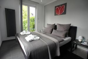 ein Schlafzimmer mit einem Bett mit Handtüchern darauf in der Unterkunft BÖ21 Luxusappartement in Büttgen
