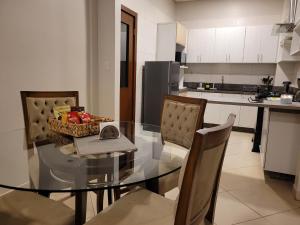 a kitchen with a glass dining table and chairs at Duplex Premium - Best Place in CDE in Ciudad del Este +11 photos