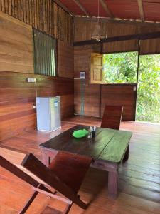 a wooden room with a table and chairs and a refrigerator at Casa Selva in El Valle +16 photos