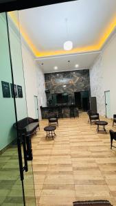 a large room with a piano and chairs in it at Rancho Paradise Aruanã GO in Aruanã