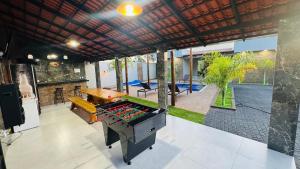 an outdoor entertaining area with a ping pong table and a pool table at Rancho Paradise Aruanã GO in Aruanã