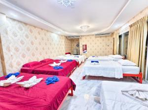 a group of four beds in a room at บ้านสวนชมจันทร์ กำแพงแสน in Ban Song Hong +52 photos