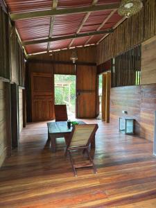 a room with a table and a bench on a wooden floor at Casa Selva in El Valle