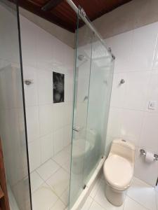 a bathroom with a toilet and a glass shower at Casa Selva in El Valle