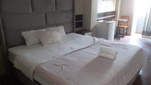 a bedroom with a large white bed with two pillows at Miraflores Thay Colonial in Lima +2 photos