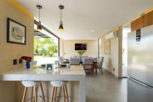 a kitchen and dining room with a table and chairs at iKAL 93 Casa Nido de Mar 9 Persons Occupancy, Pool, 7 Beds in Nuevo Vallarta