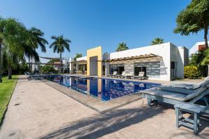 an image of a swimming pool at a resort at iKAL 93 Casa Nido de Mar 9 Persons Occupancy, Pool, 7 Beds in Nuevo Vallarta