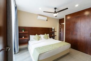 a bedroom with a white bed and a wooden door at iKAL 93 Casa Nido de Mar 9 Persons Occupancy, Pool, 7 Beds in Nuevo Vallarta +40 photos