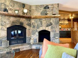a large stone fireplace in a living room at Cajun Cabin Private Nature Resort in Minden