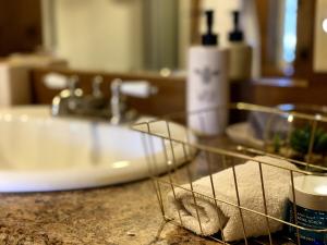a bathroom counter with a sink and a towel at Cajun Cabin Private Nature Resort in Minden +69 photos