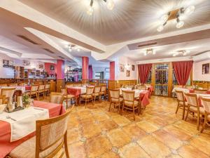 a restaurant with tables and chairs in a room at Хотел Елит Релакс in Devin