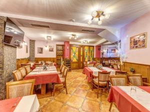 a restaurant with tables and chairs in a room at Хотел Елит Релакс in Devin