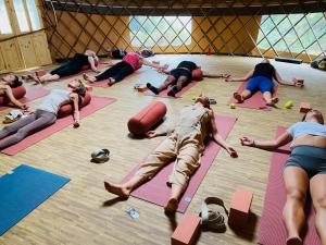 a group of people doing yoga in a gym at JOY Retreat in Isle of Jersey