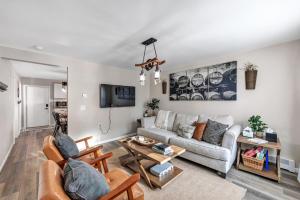 a living room with a couch and a table at Newly renovated-across the street from Von Stiehl! in Algoma
