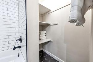 a bathroom with white walls and a shower with towels at Newly renovated-across the street from Von Stiehl! in Algoma +14 photos